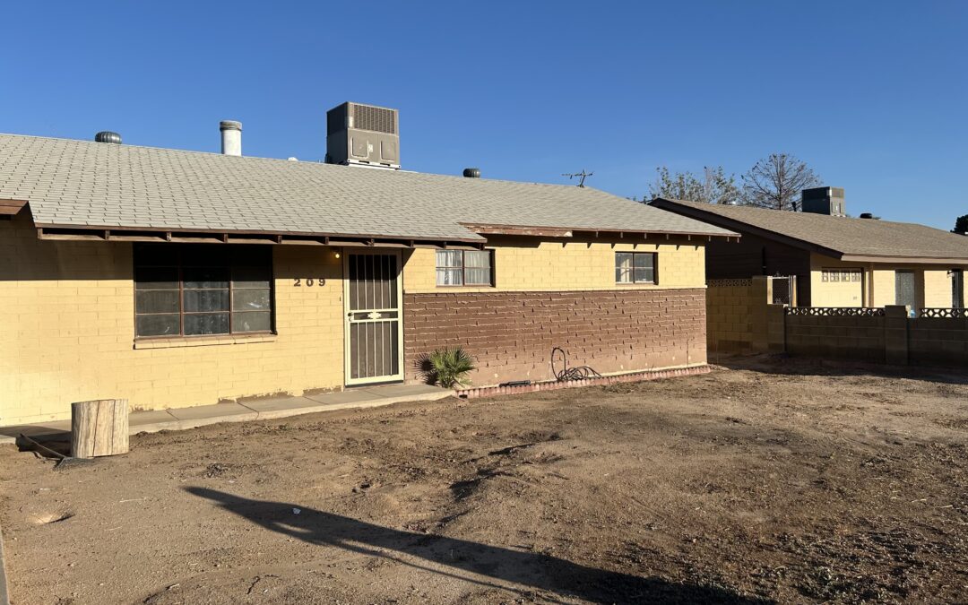 Actual inherited Arizona block home purchased by Shrubby with a dry yard and older rooftop air conditioning